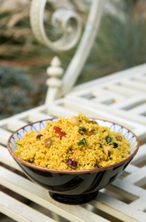 Food, Cooked, Pasta, Bowl of Moroccan couscous with fruit nuts and vegetables on a metal table in a