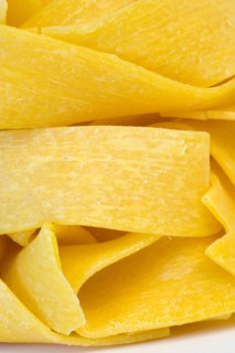 Food, Uncooked, Pasta, Ribbons of durum wheat Pappardelle against a white background.