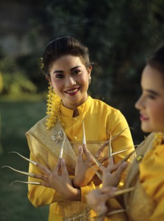 Thailand, women in traditional dress with nail extensions.