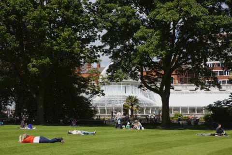 Ireland, Northern, Belfast, Botanic Gardens with people sat on benches outside the Palm House next