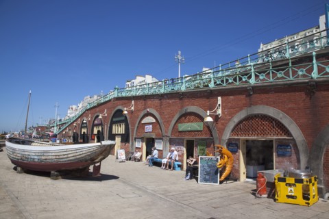 England, East Sussex, Brighton, seafront arches undeer the promenade housing the fishermans club