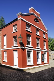 Omagh, County Tyrone, Ireland. Ulster American Folk Park red coloured house in the reconstructed