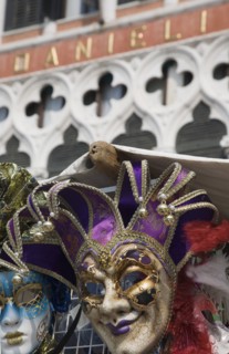 Venice, Veneto, Italy. Carnival masks in front of partly seen facade of Hotel Danieli. Italy Italia