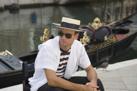 Venice, Veneto, Italy. Centro Storico Young gondolier in traditional uniform of striped shirt and