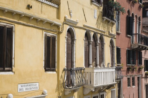 Venice, Veneto, Italy. Restored facades of canalside buildings painted pastel pink terracotta and