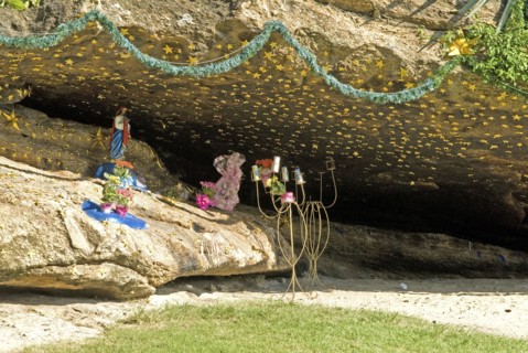 Rio de Janeiro, Brazil. Grotto in rocks in Arpoador Park off Ipanema beach with statue of Jesus