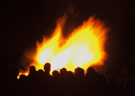 Shoreham Beach, West Sussex, England. Festivals Guy Fawkes Bonfire People silhouetted by flames