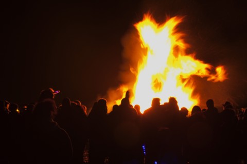 Shoreham Beach, West Sussex, England. Festivals Guy Fawkes Bonfire People silhouetted by flames