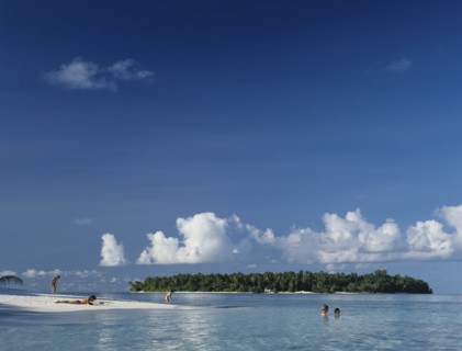 Beach, Maldives. Beach with tourist sunbathing and swimming in the Indian Ocean. Maldives Island