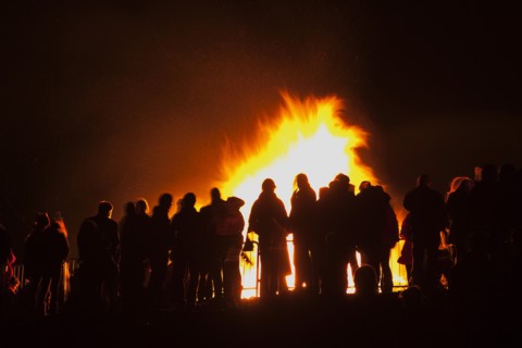 Shoreham Beach, West Sussex, England. Festivals Guy Fawkes Bonfire People silhouetted by flames