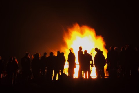 Shoreham Beach, West Sussex, England. Festivals Guy Fawkes Bonfire People silhouetted by flames