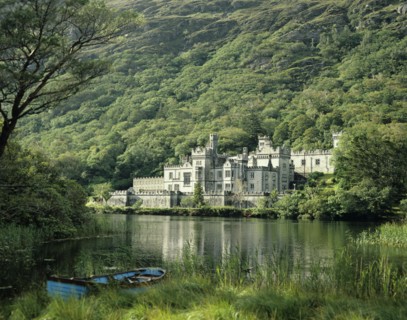 Connemara, County Galway, Ireland. Kylemore Abbey with lake in the foreground. Ireland Irish County