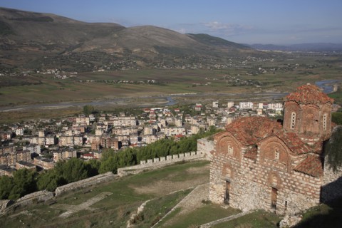 Berat, Albania. St Triada Church on the right with Berat new town beside the River Osum in the