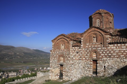 Berat, Albania. St Triada Church on the right with Berat new town beside the River Osum in the