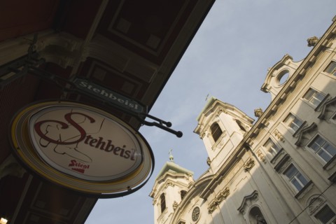 Vienna, Austria. Circular bar sign with Empire era building facade behind. Austria Austrian