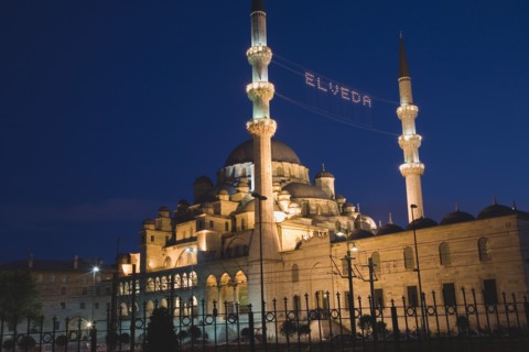 Istanbul, Turkey. Sultanahmet. The New Mosque or Yeni Camii at dusk with illuminated sign which