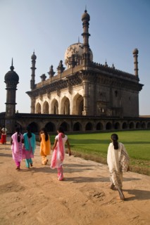 Bijapur, Karnataka, India. Tomb of Ibrahim Rauza with group of young women wearing brightly