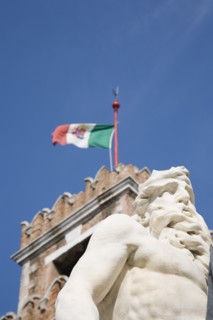 Venice, Veneto, Italy. Centro Storico Arsenale Part view of crenellated tower flying Italian