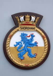 HMS Shoreham emblem on board the mine sweeper. Sign Signs Emblem Coat Arms Military Naval Royal