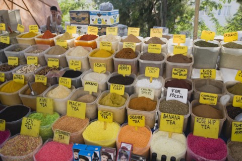 Kusadasi, Aydin Province, Turkey. Stall at weekly market selling spices and tea powders in brightly