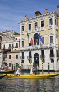 Venice, Veneto, Italy. Female pair taking part in Regata Storica Venice Regatta rowing yellow