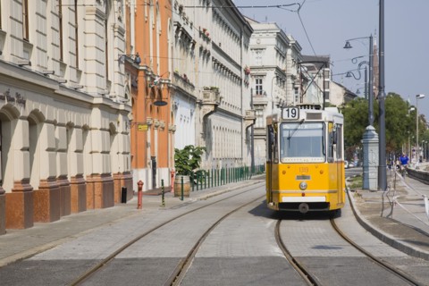 Budapest, Pest County, Hungary. Tram on bank of the River Danube Buda at approach to Chain Bridge.