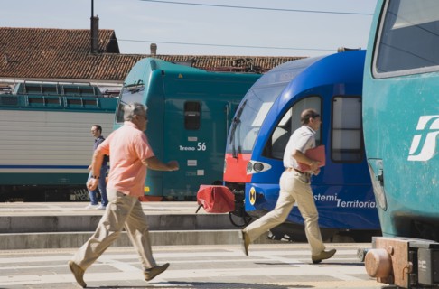 Venice, Veneto, Italy. Commuters running to board local train with regional trains on platforms at