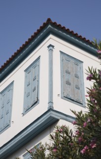 Samos Island, Northern Aegean, Greece. Vathy. Part view of house facade with tiled roof and blue
