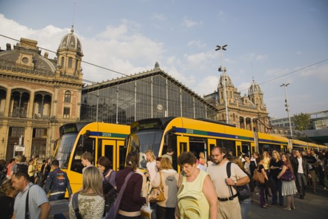 Budapest, Pest County, Hungary. Budapest trams and crowd of passengers in front of rail terminus