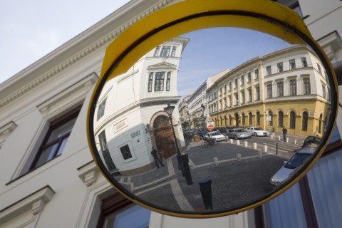 Budapest, Pest County, Hungary. Circular traffic guiding mirror reflecting apartments on River