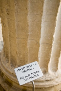 Athens, Attica, Greece. Acropolis Propylaea gate part view with Do not touch the Marble sign.