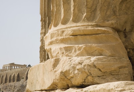 Athens, Attica, Greece. Base of ruined column on The Temple of Olympian Zeus with Parthenon and