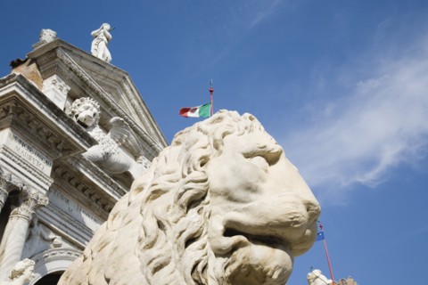 Venice, Veneto, Italy. Centro Storico Arsenale Castello with guardian lion statue in foreground and