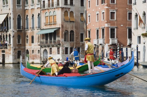 Venice, Veneto, Italy. Participants in the Regata Storico annual historical regatta in brightly