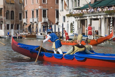 Venice, Veneto, Italy. Participants in the Regata Storico historical Regatta in brightly painted