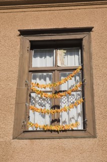 Kusadasi, Aydin Province, Turkey. Strings of yellow and orange chili peppers hanging from wooden