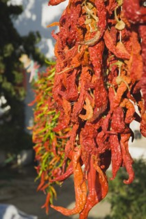 Sirince, Aydin Province, Turkey. Strings of brightly coloured red and green chilies hanging up to