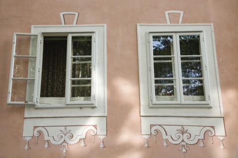 Vienna, Austria. Part view of restored facade of building with pair of windows one open with white