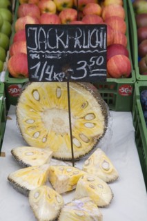 Vienna, Austria. The Naschmarkt. Jack Fruit for sale on fruit stall cut in half and into wedges.
