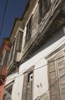 Kusadasi, Aydin Province, Turkey. Exterior facades of Ottoman era whitewashed plaster and wooden