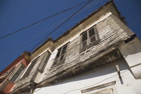 Kusadasi, Aydin Province, Turkey. Angled part view of exterior facade of Ottoman era whitewashed