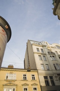 Vienna, Austria. Building exterior facades with partly seen advertising column in foreground.