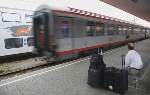 Vienna, Austria. Wien Westbahnhof. Passenger with luggage sitting on Vienna West Station with