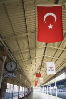 Istanbul, Turkey. Sultanahmet. View along railway platform with Turkish flags hanging from the roof