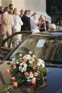 Budapest, Pest County, Hungary. Bride and groom greeting wedding guests on steps of Saint Stephens