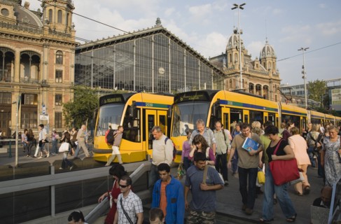 Budapest, Pest County, Hungary. Trams and crowd of passengers in front of rail terminus Budapest