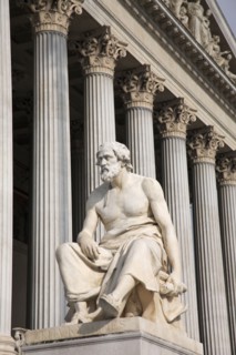 Vienna, Austria. Statue of the Greek philosopher Thucydides in front of the columns to the