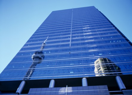 Toronto, Ontario, Canada. The CN Tower reflected in Front Street glass fronted building Canadian