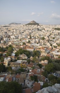 Athens, Attica, Greece. Mount Lycabettus rising in central Athens with densely populated city below