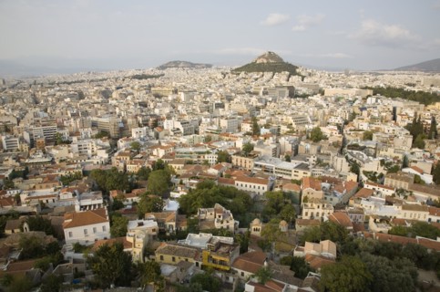 Athens, Attica, Greece. Mount Lycabettus rising in central Athens with densely populated city below